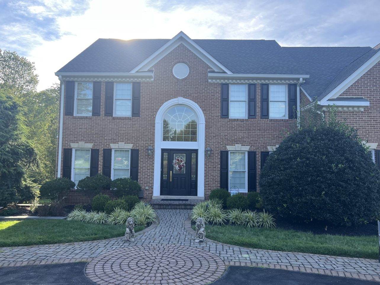 Brick colonial home with a new shingle roof