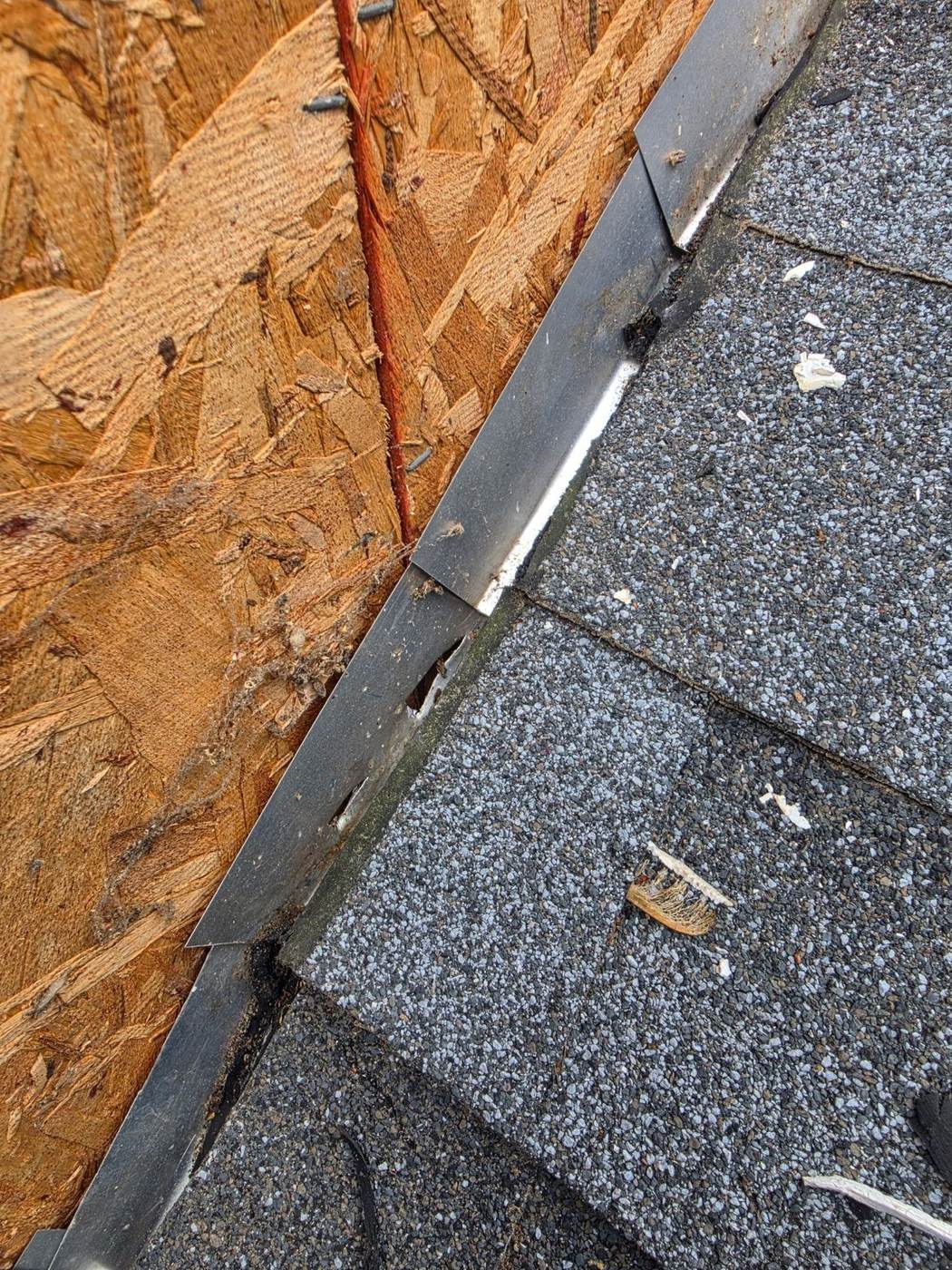 Close-up of step flashing along a wall — failing flashing is one of the most common and most repairable leak sources.